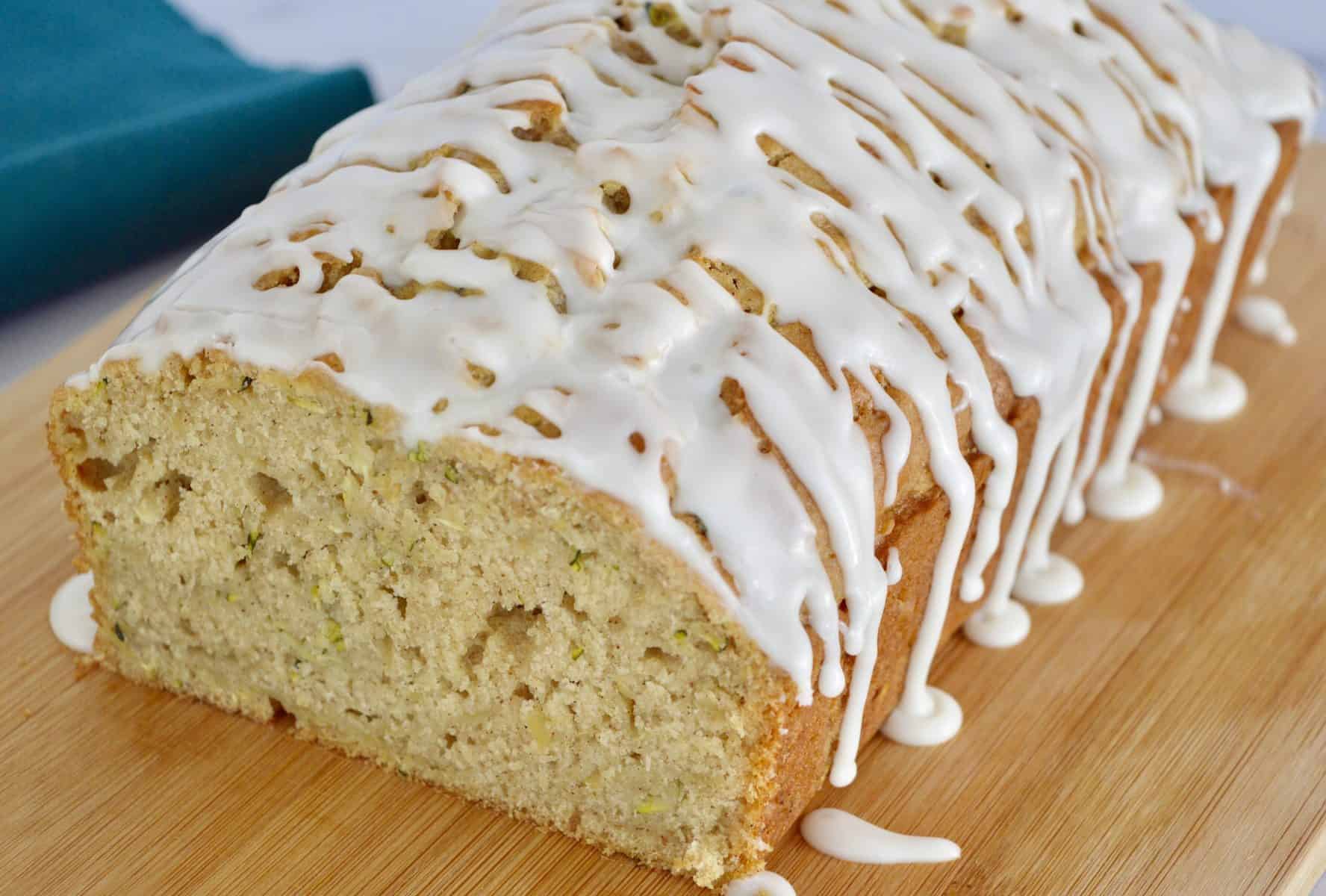 Glazed Zucchini Apple Bread on a wood cutting board.