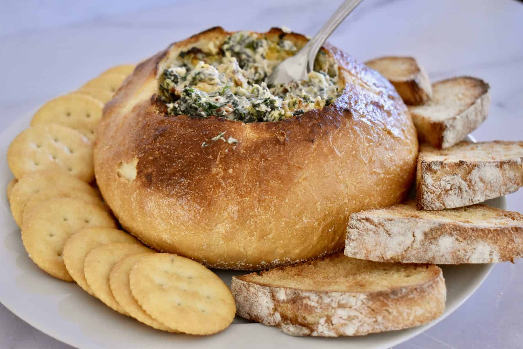 Bacon Spinach Dip Loaf with ritz crackers and toasted bread. 