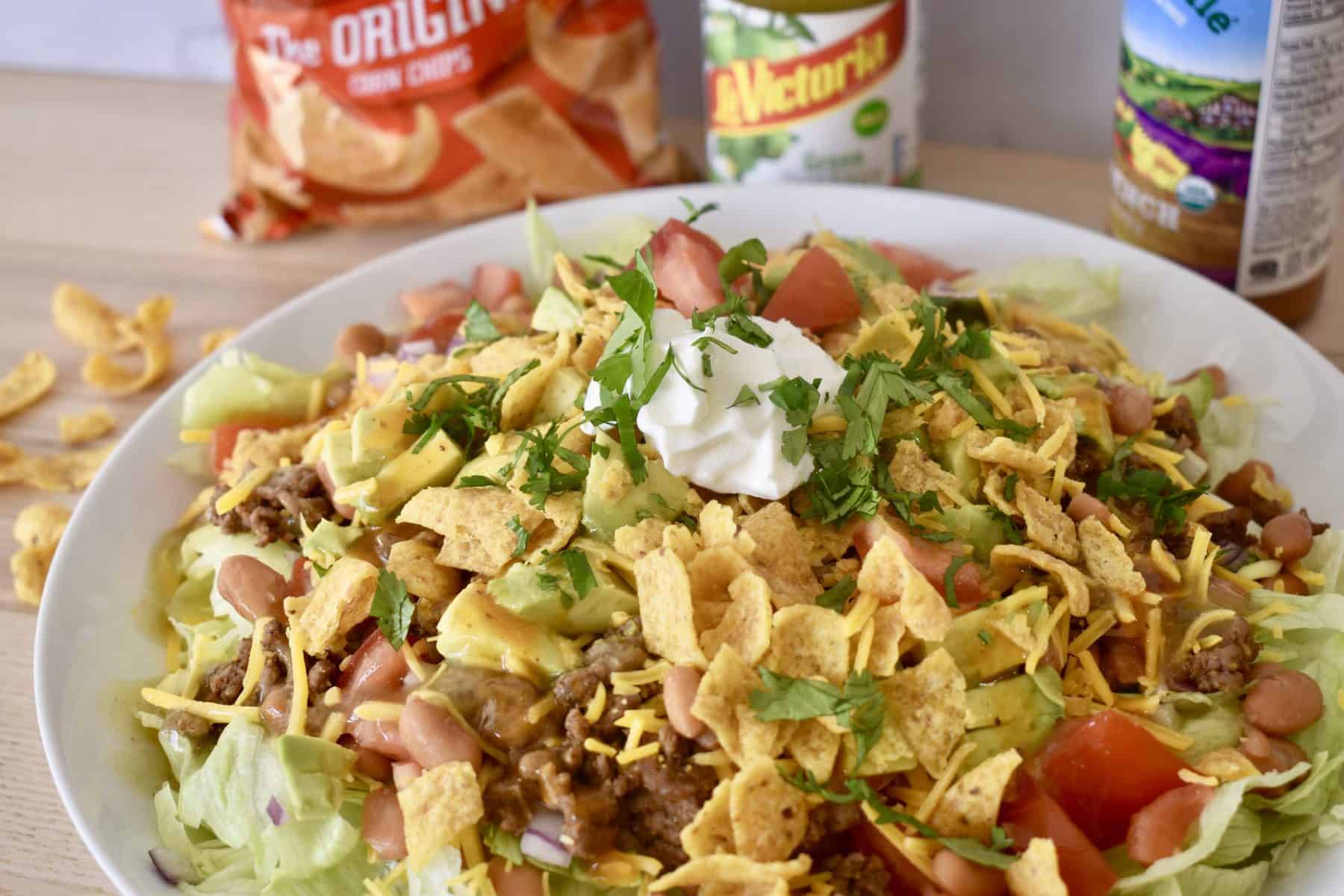 Frito Taco Salad with French dressing and green taco sauce. 