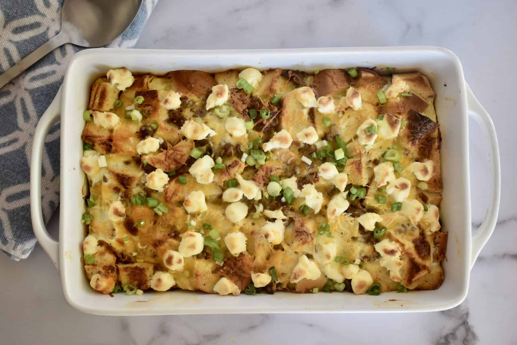 Everything Bagel Sausage Bake in a white casserole dish. 