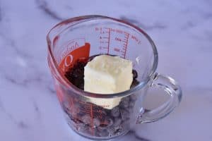 butter, chocolate chips, and corn syrup in a glass measuring cup.