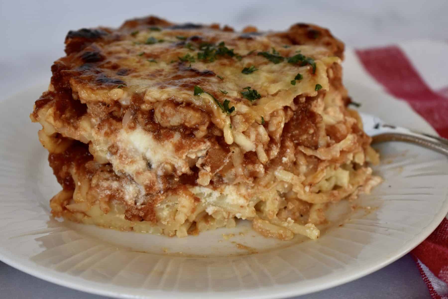 Baked Spaghetti with ground turkey on a white plate. 