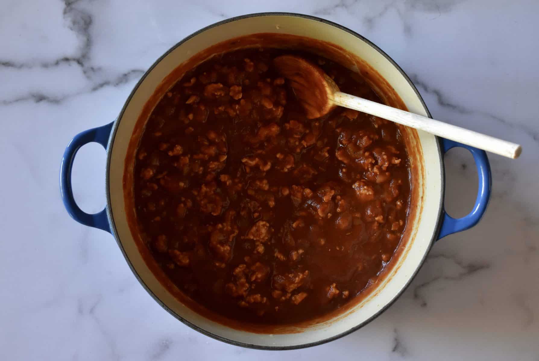 meat sauce in a pot with a spoon. 