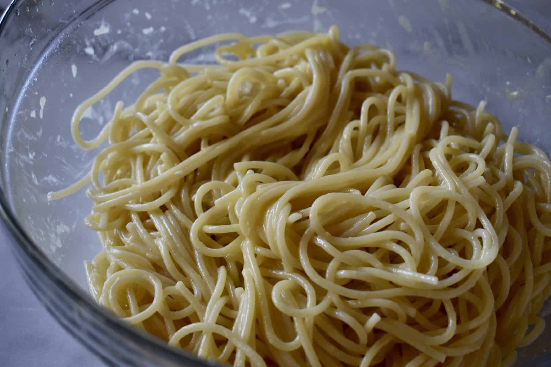 bowl of pasta tossed with eggs, butter, and parmesan cheese. 