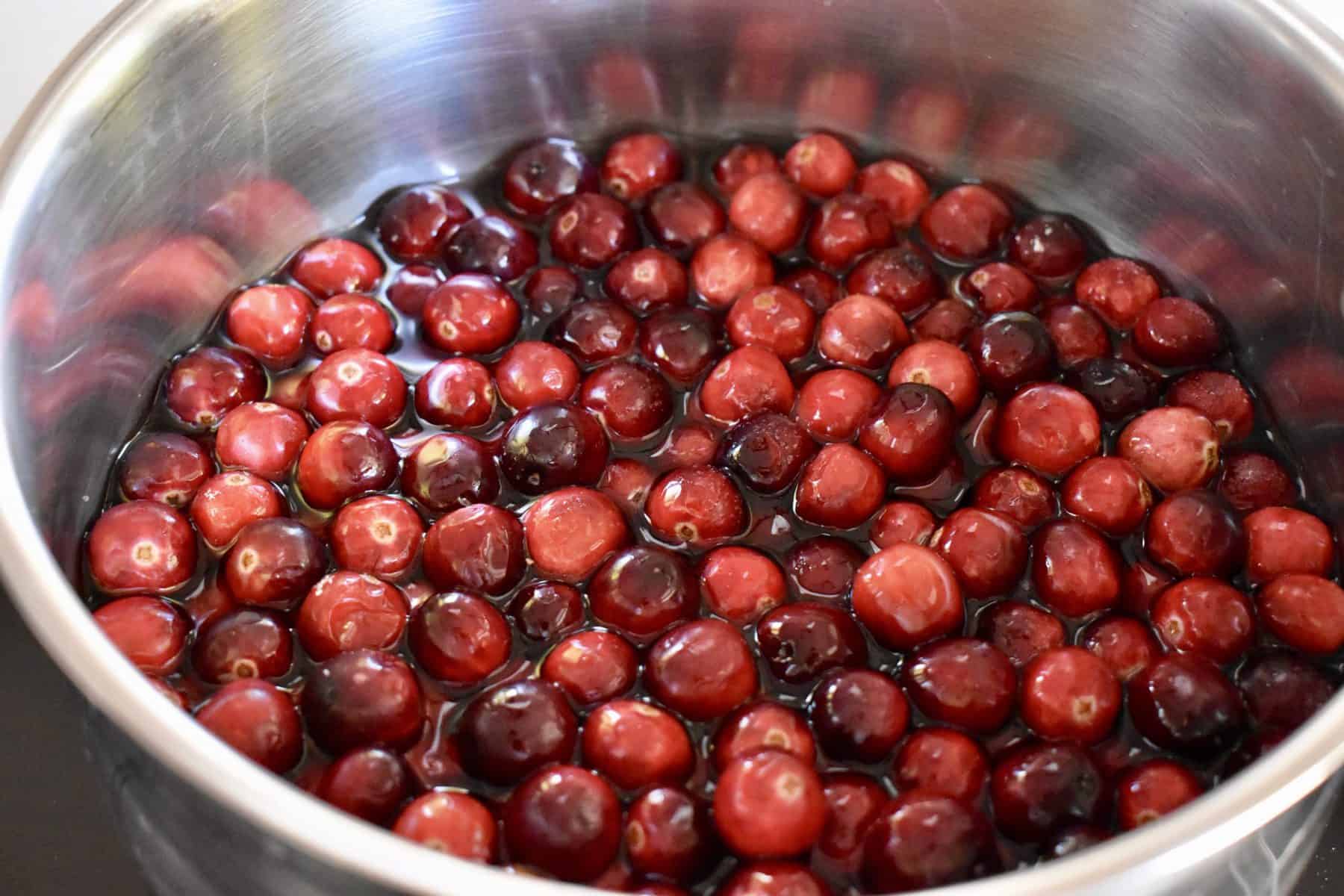 cranberries, sugar, and water in pot