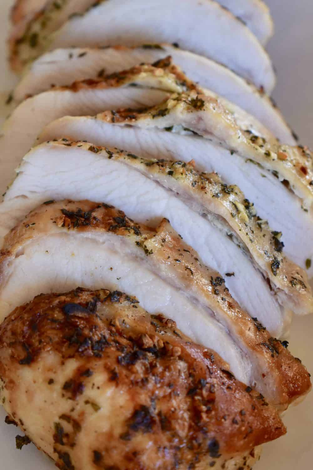 Slow cooker turkey breast on white serving platter.