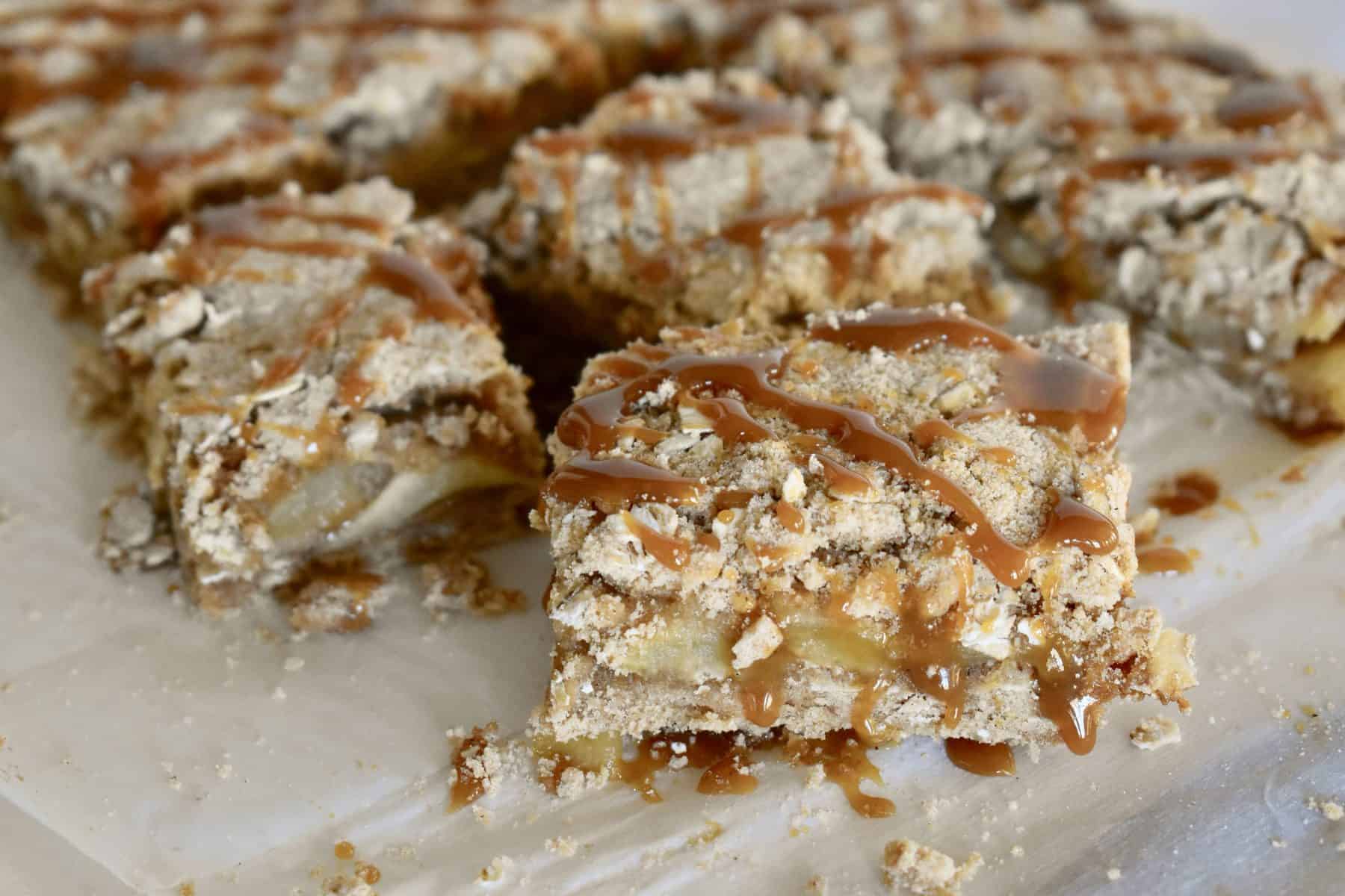 Fresh Caramel Apple Squares on white parchment paper. 