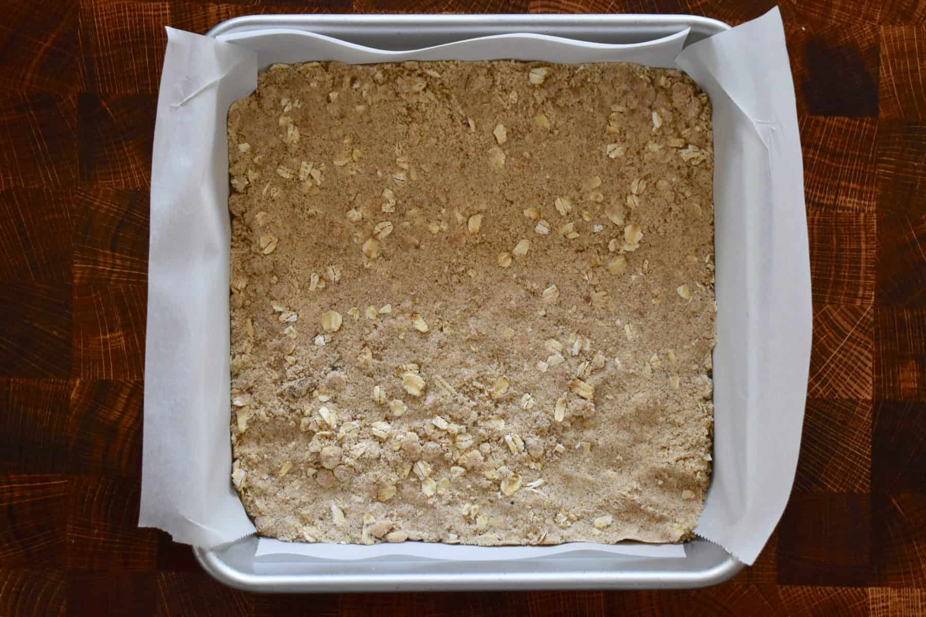 dough firmly pressed into a lined baking pan. 