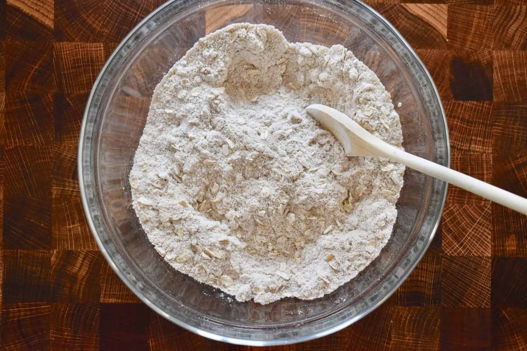 flour, oats, cinnamon, nutmeg, salt, and baking powder in a glass bowl. 
