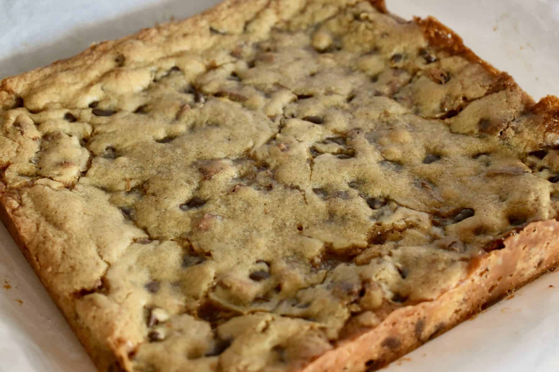 Baked Milky Way Blondies on white parchment paper. 