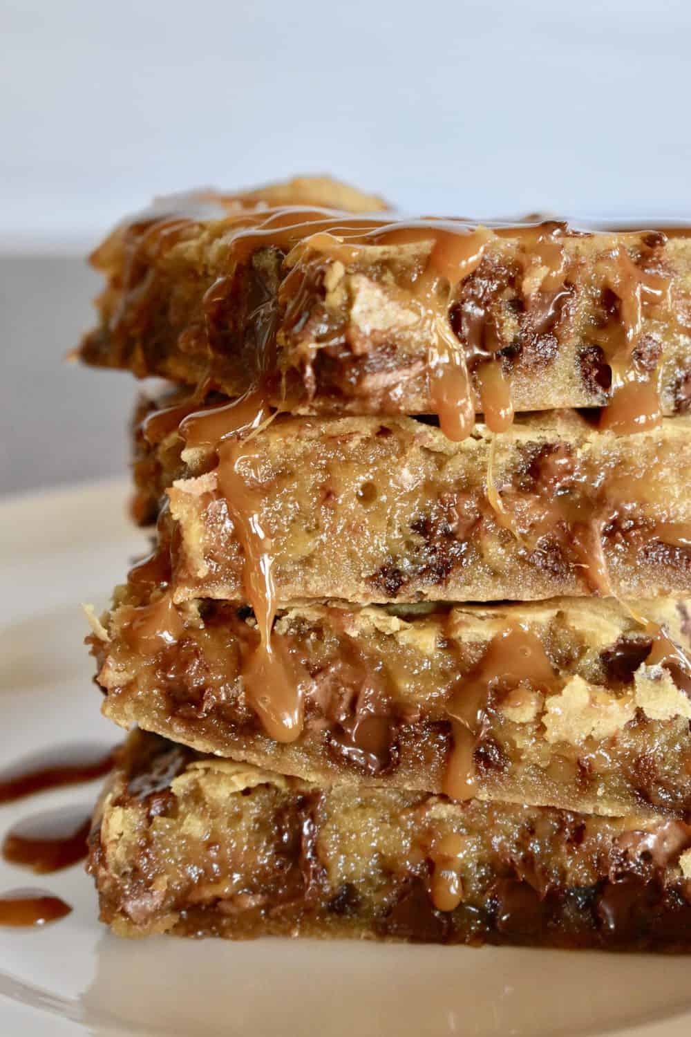 Milky Way Blondies stacked with caramel sauce drizzle.