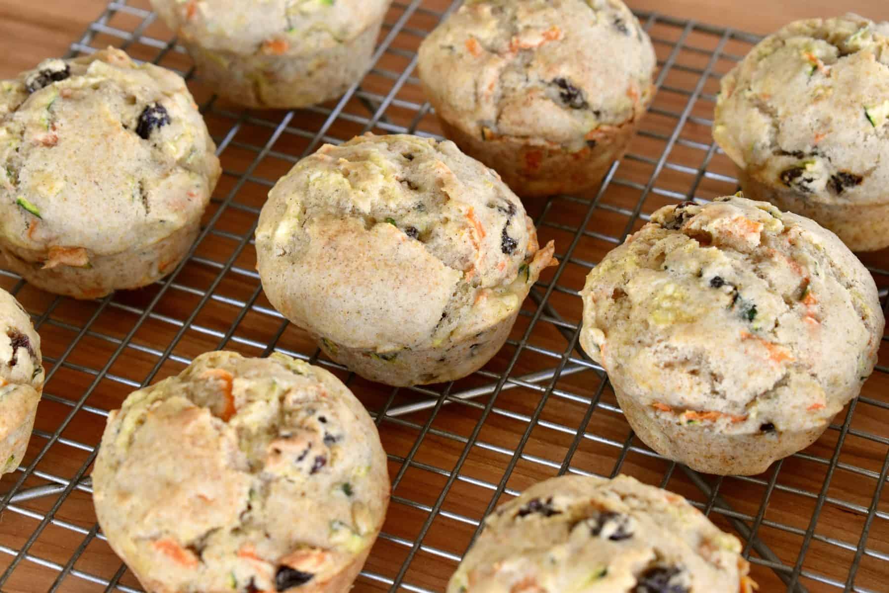 Zucchini Carrot Raisin Muffins on a wire cooling rack.