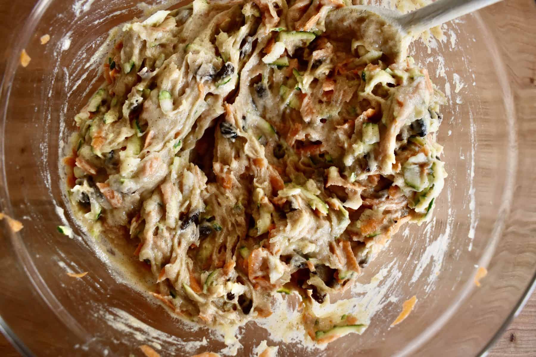 Zucchini Carrot Raisin muffin batter in a glass bowl. 