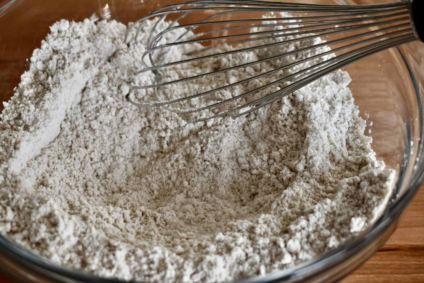 flour, baking powder, cinnamon and salt in glass bowl with a whisk. 