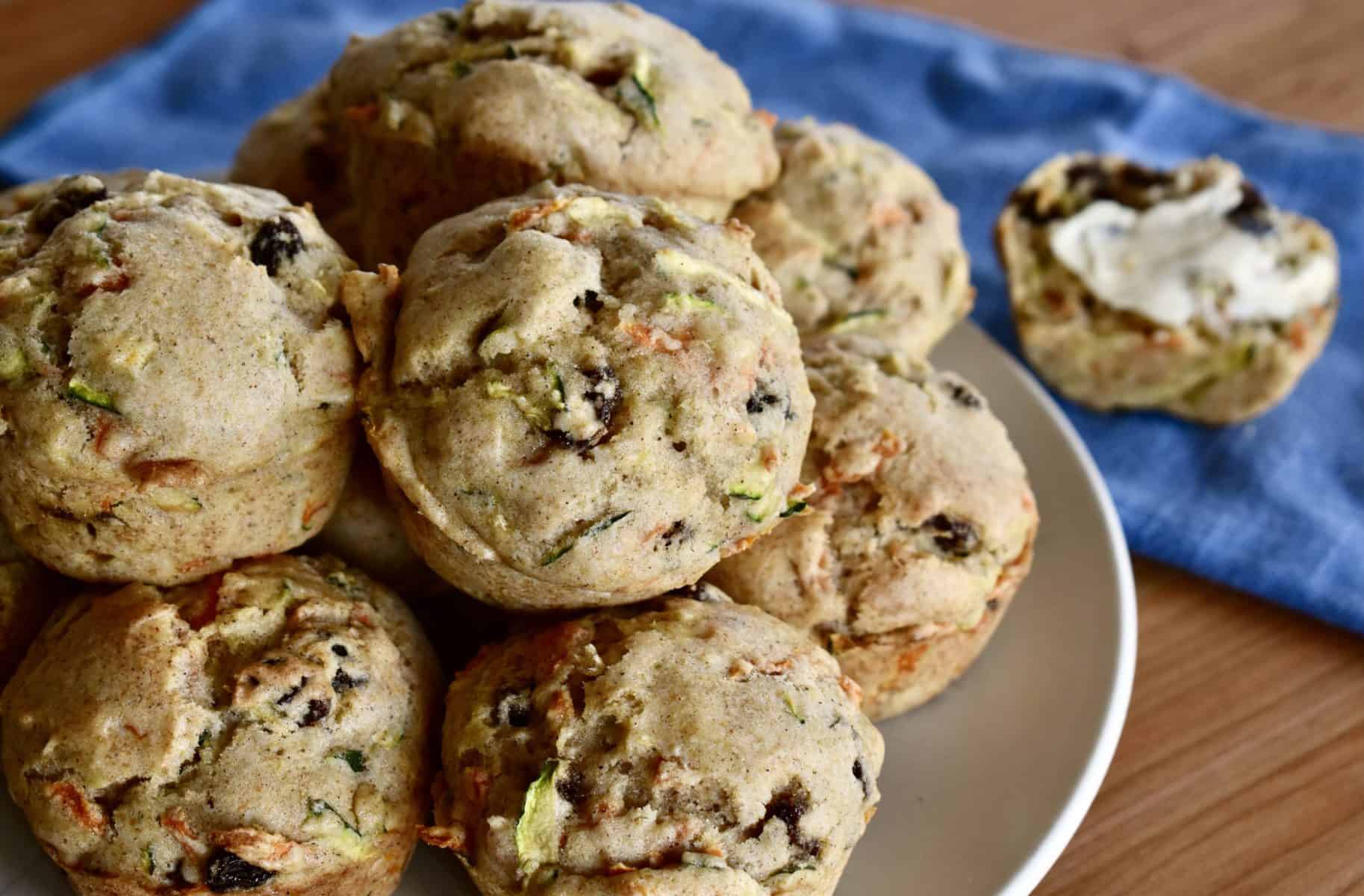 Zucchini Carrot Raisin Muffins piled on a plate. 