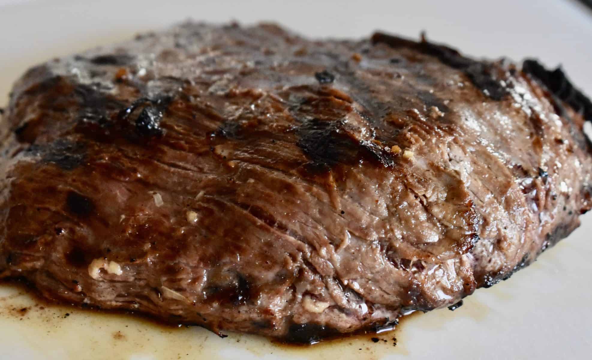 Meat sitting on a cutting board.