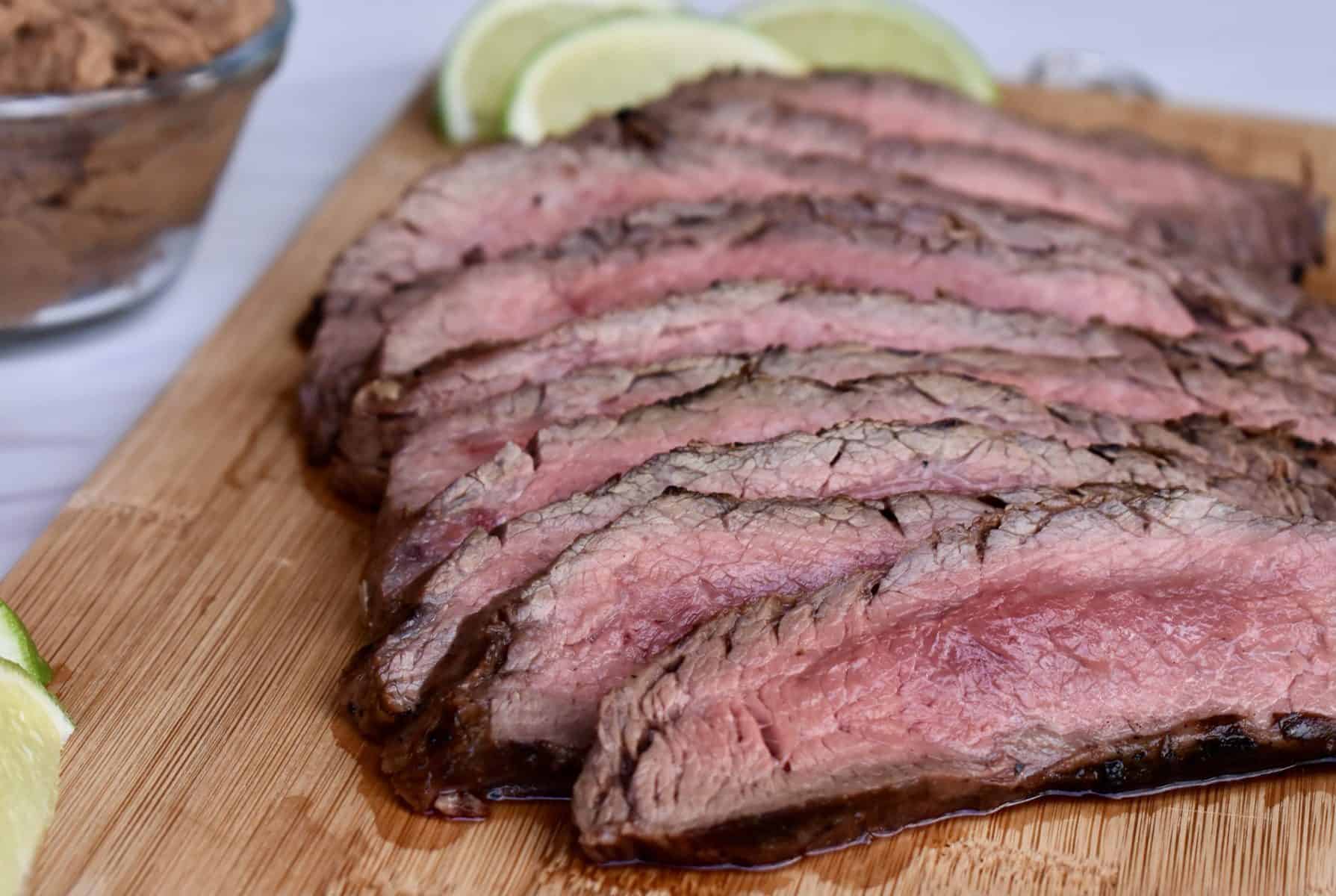 Sliced meat on a wood cutting board. 