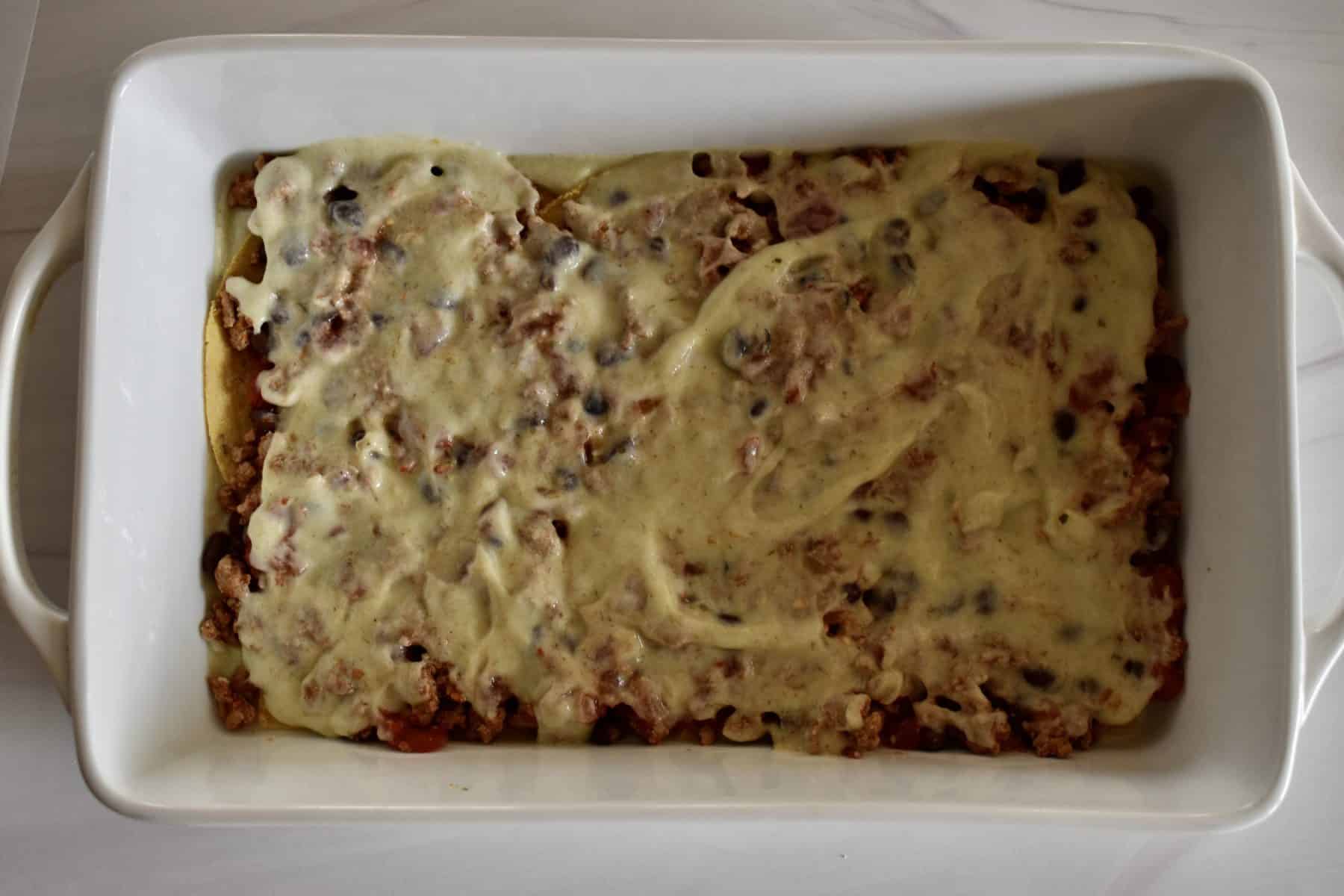 enchilada sauce spread overtop of the meat mixture. 