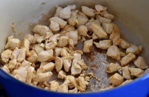 chicken and garlic cooking in a pot