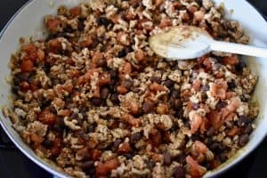 skillet with ground turkey, black beans, and diced tomatoes.