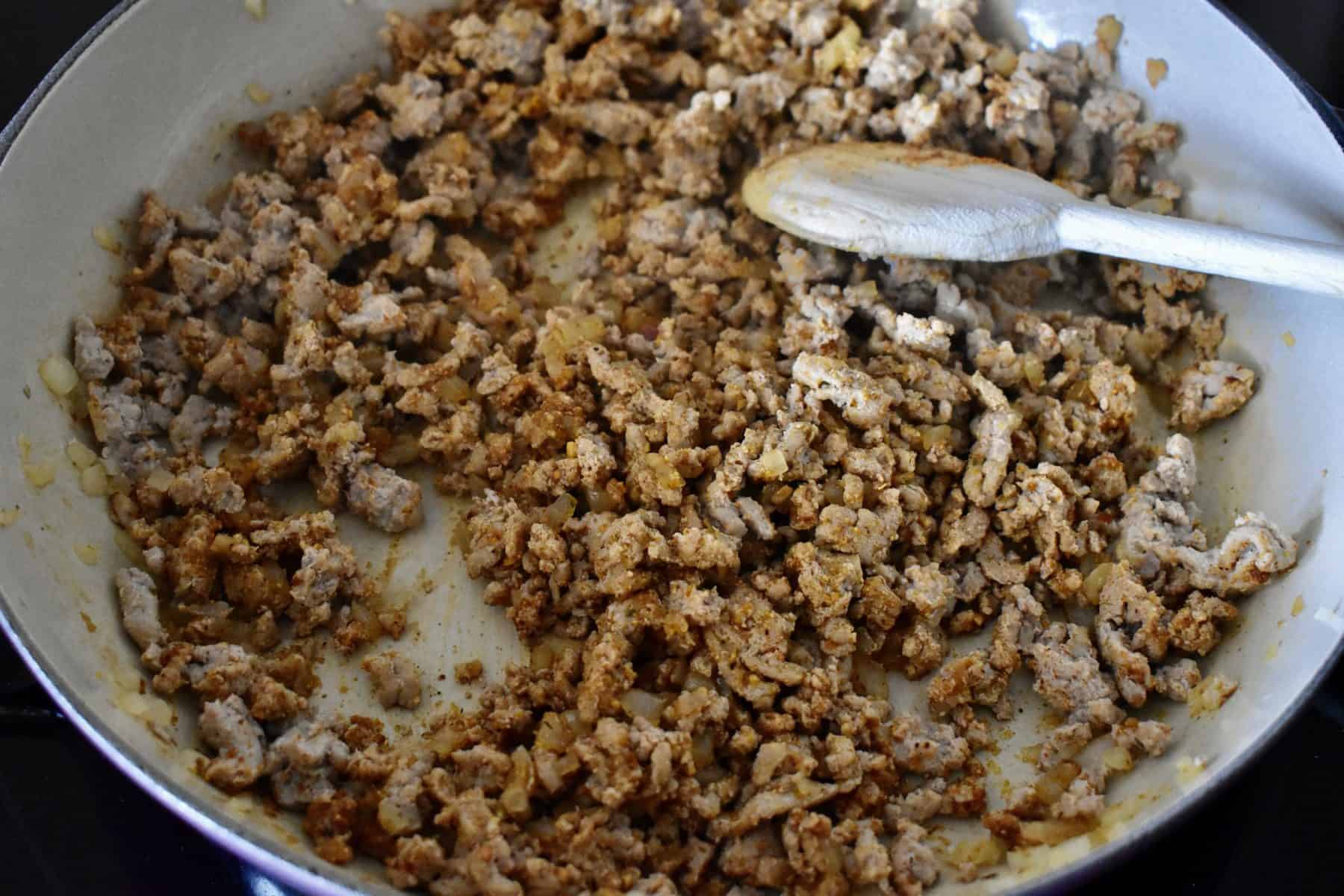 large pan with browned turkey and onions. 