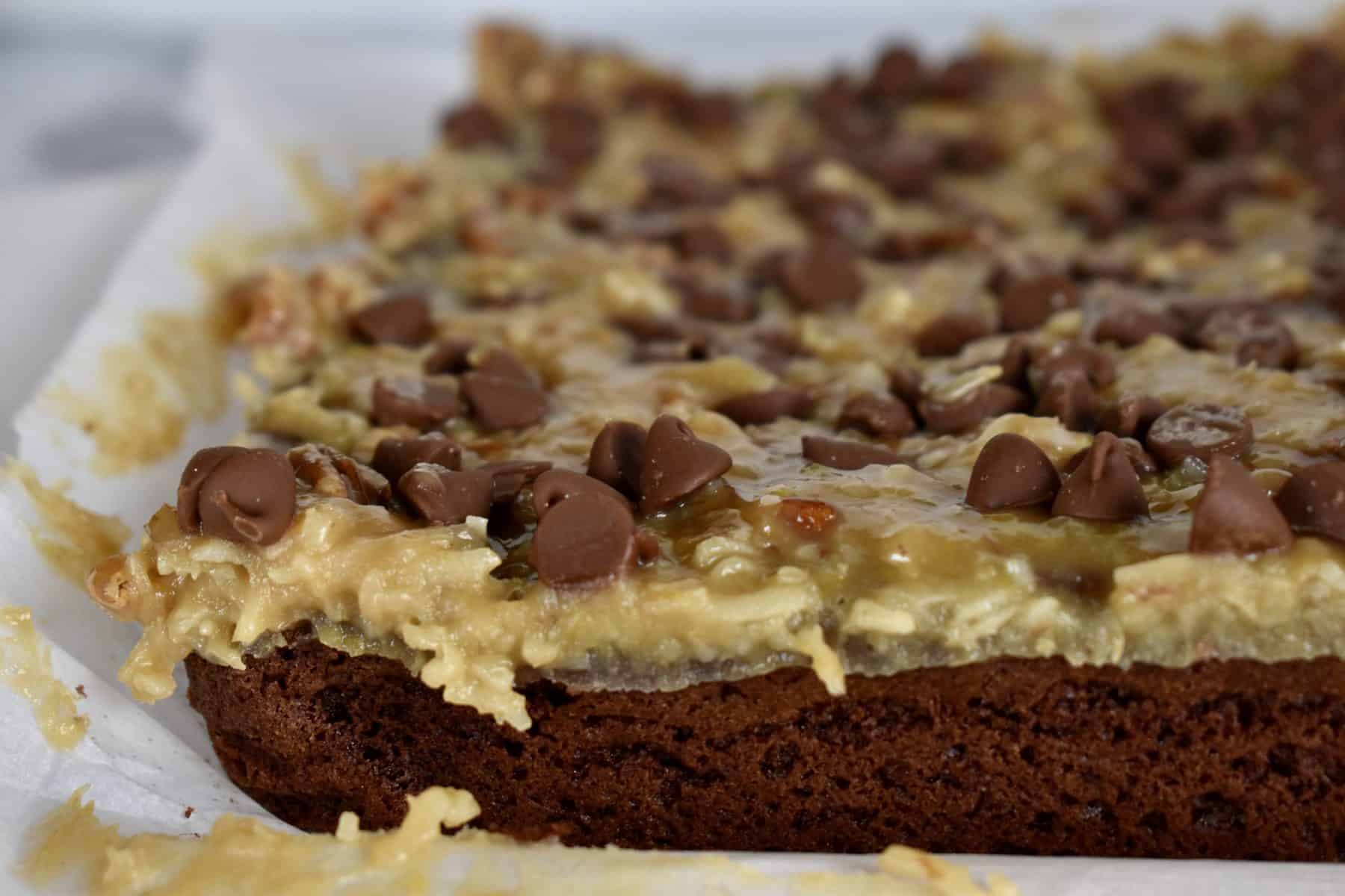 German chocolate brownies on a piece of parchment paper. 