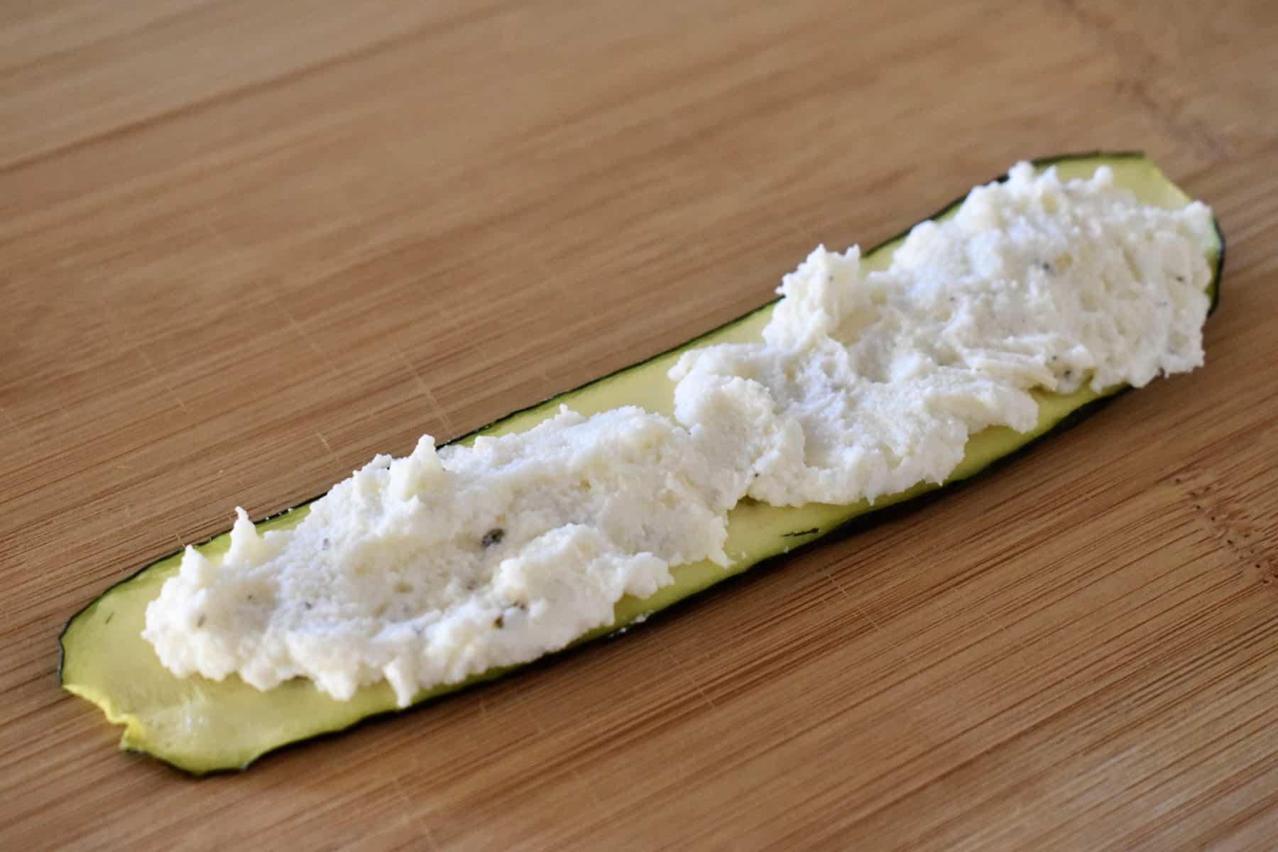 ricotta cheese mixture spread over top of the cooked zucchini slices.