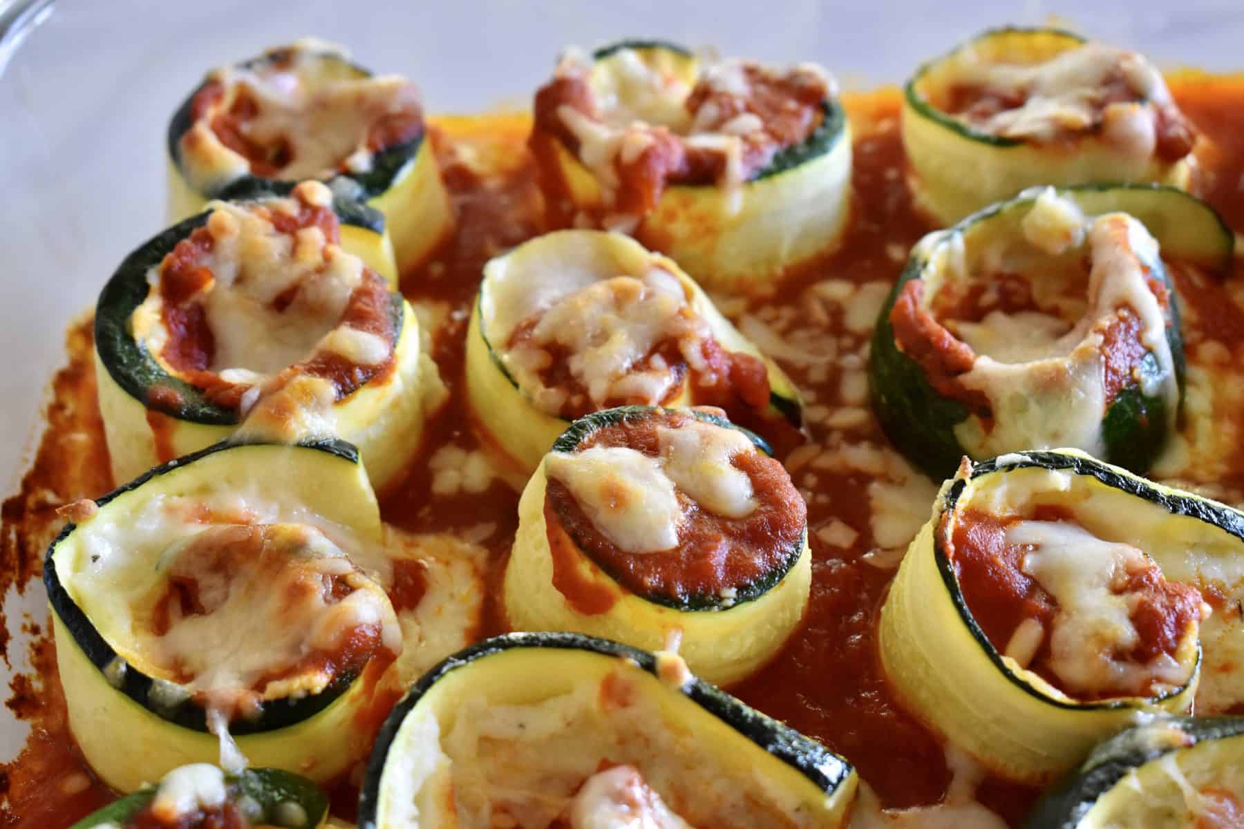 Zucchini Ricotta Roll Ups in a glass baking dish. 