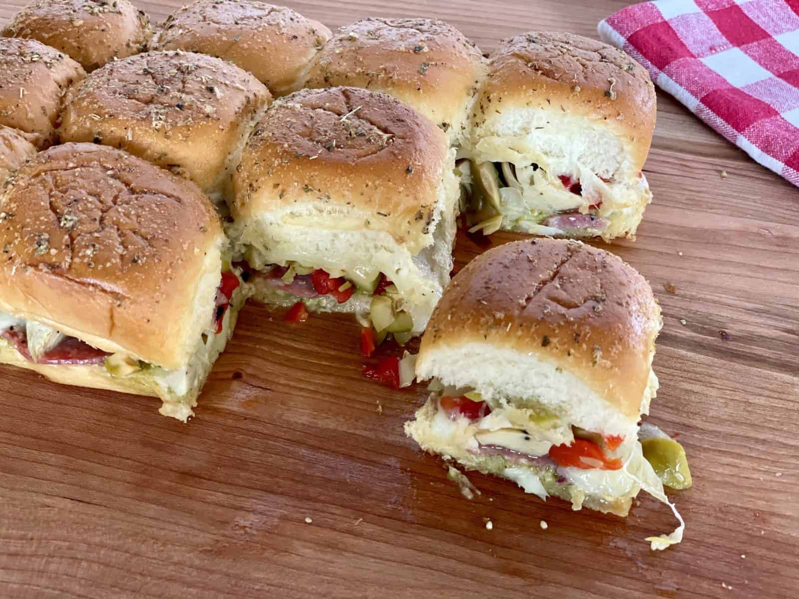 Antipasto Sliders on a wood cutting board. 