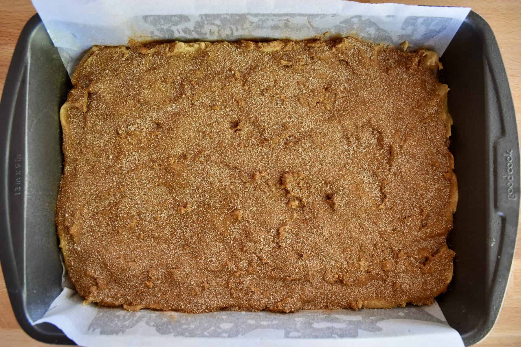 sugar mixture sprinkled over top of the battle in the baking pan.  