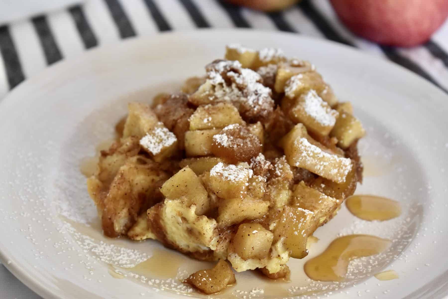Croissant Baked French Toast with Cinnamon Apples on a white plate. 