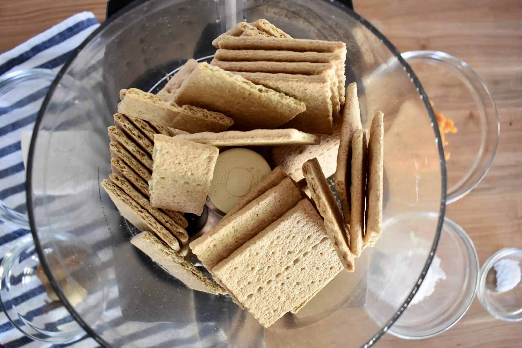 Overhead photo of graham crackers in a food processor. 