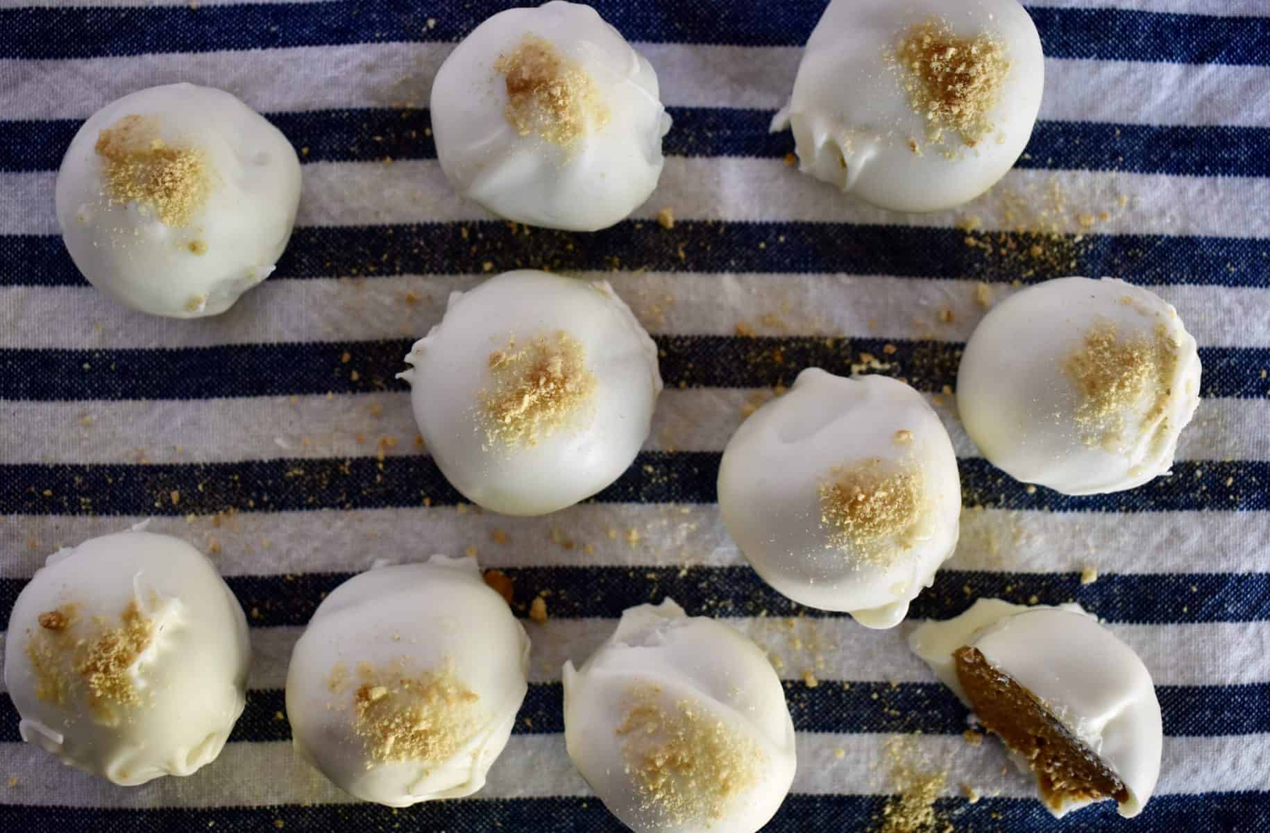 overhead photo of pumpkin spice truffles on a white and blue cloth. 