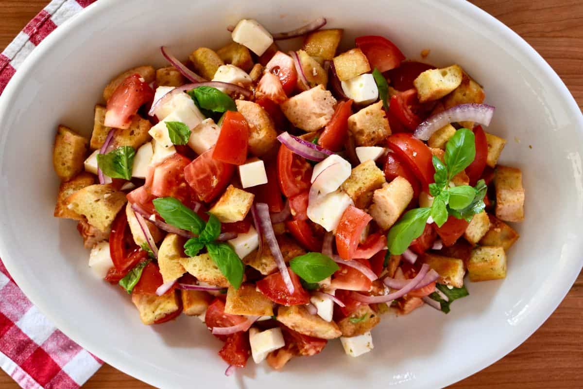overhead photo of bruschetta salad in a white serving bowl. 