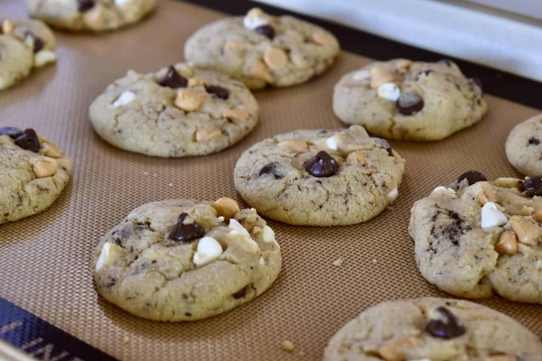 Triple Chocolate Chip Cookies on a baking sheet fresh from the oven. 