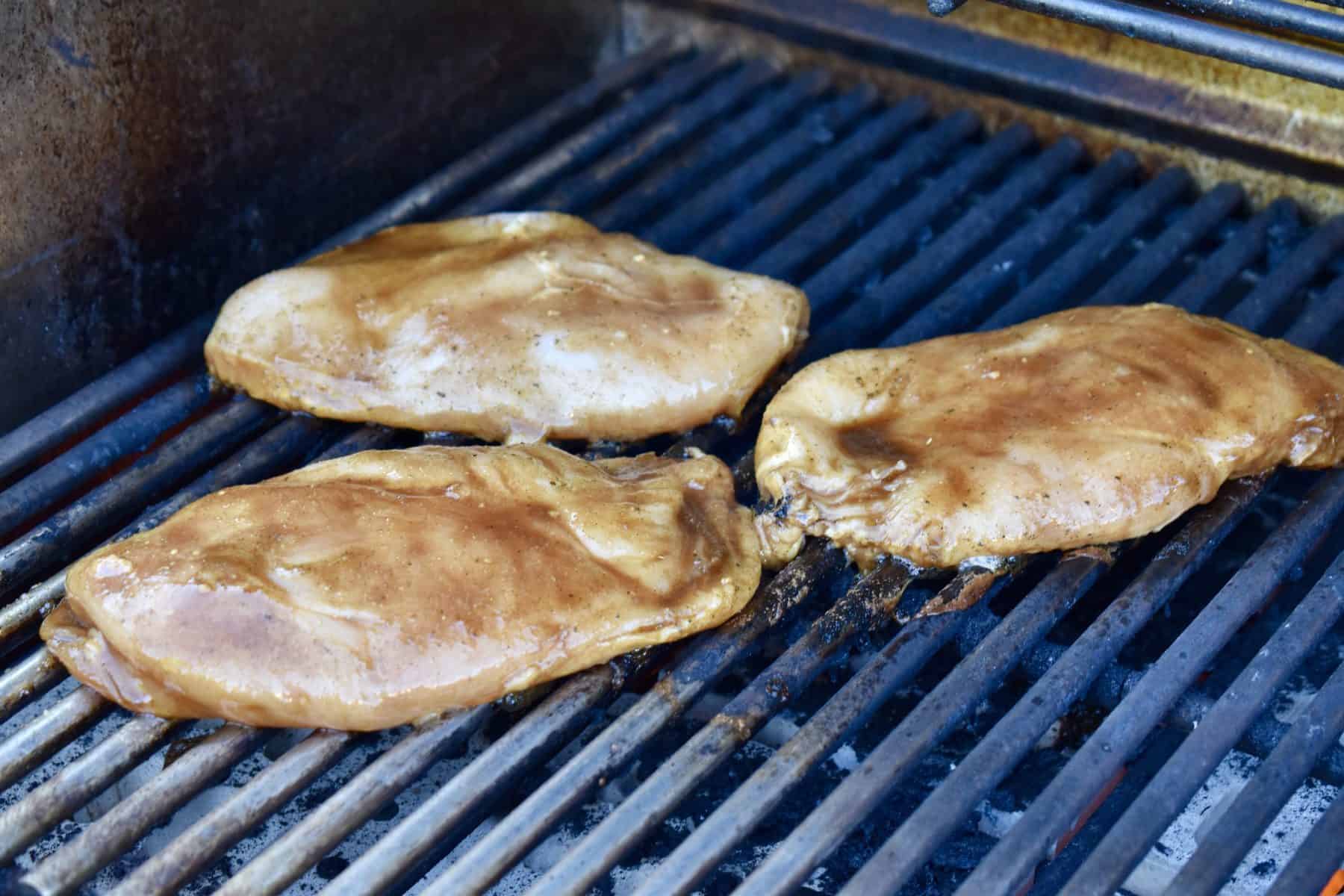 chicken breasts on a grill. 