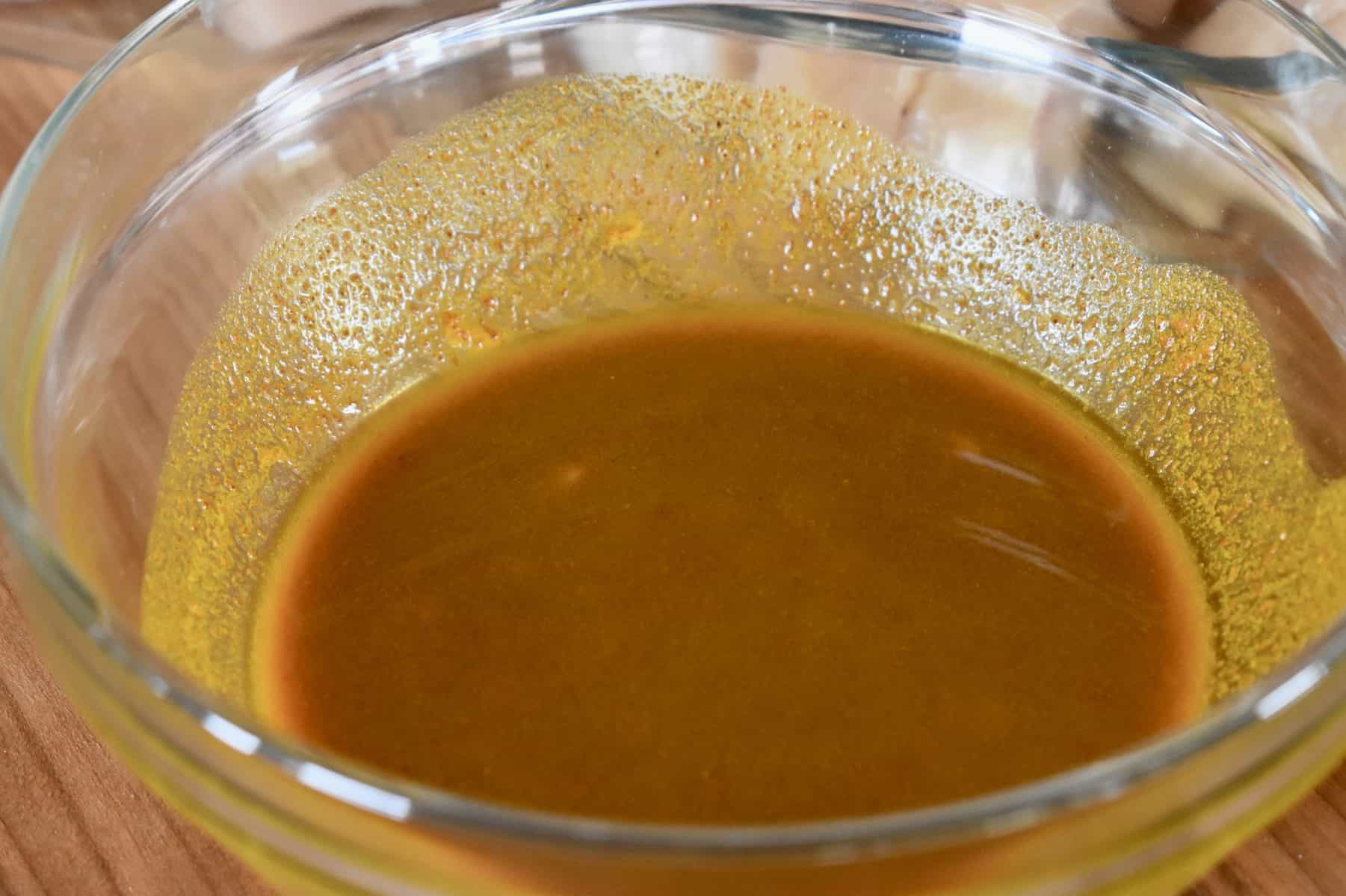 turmeric garlic marinade in a glass bowl. 