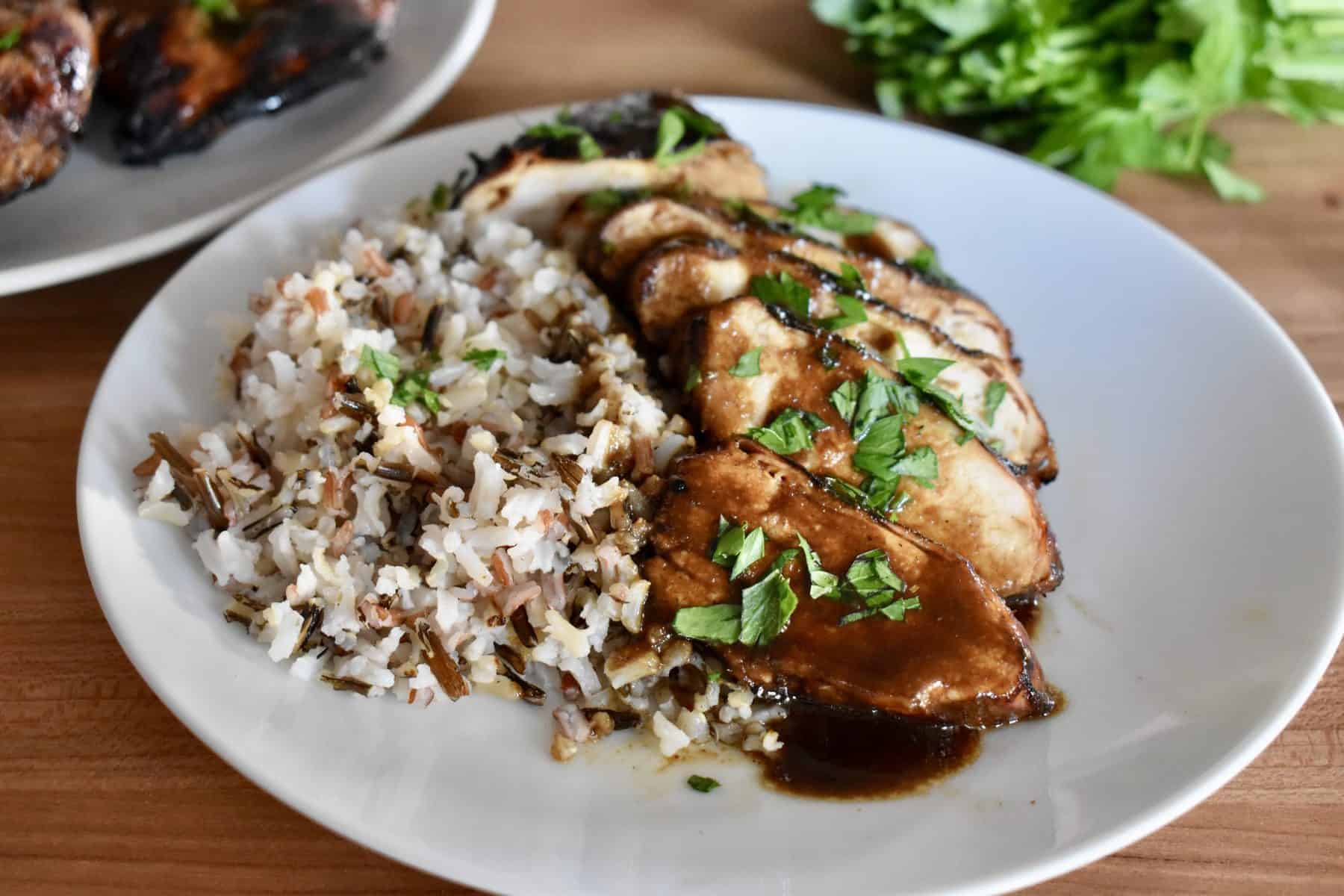 chicken on plate with rice and balsamic glaze. 