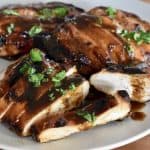 Grilled Marinated Chicken with Balsamic sauce on a white plate.