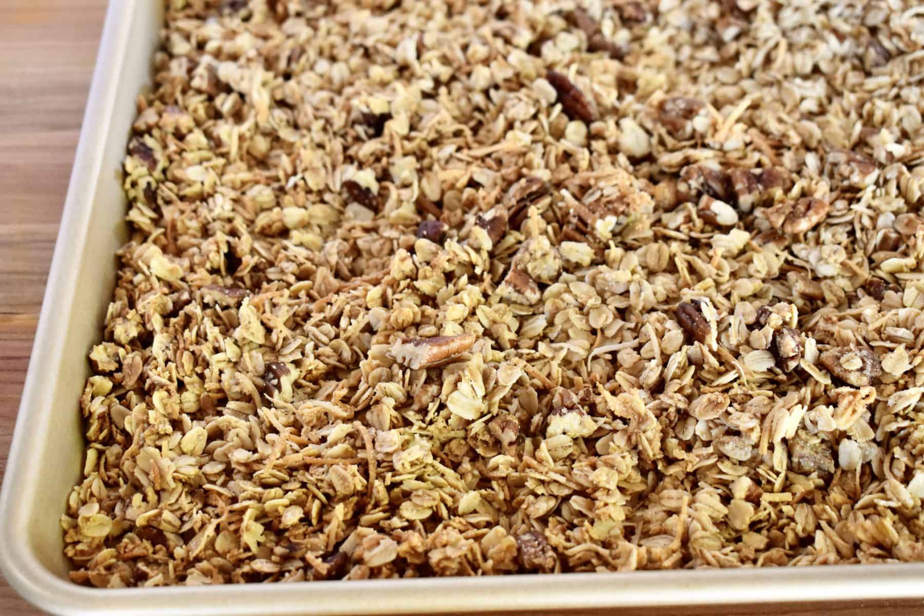 close up of coconut pecan granola in baking sheet. 