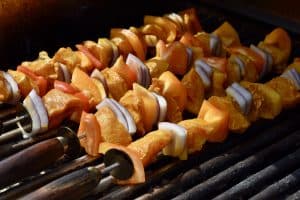 chicken skewers on a outdoor barbecue grill.