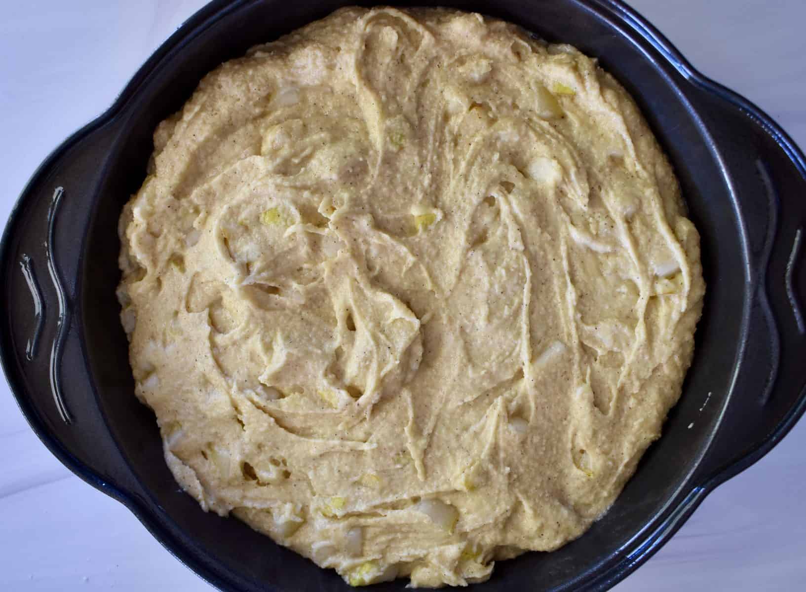 overhead photo of almond flour pear cake batter in a cake pan. 