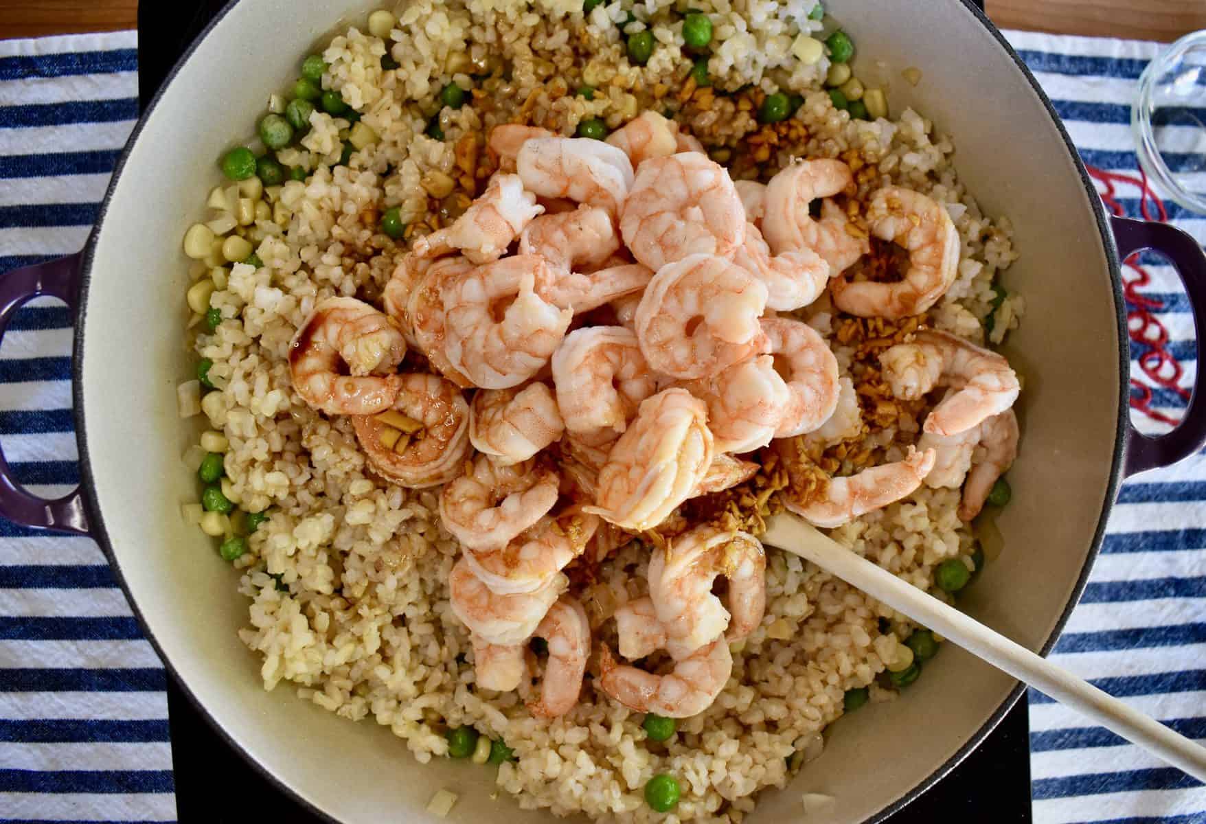 overhead photo of pan of shrimp fried rice with shrimp on top. 