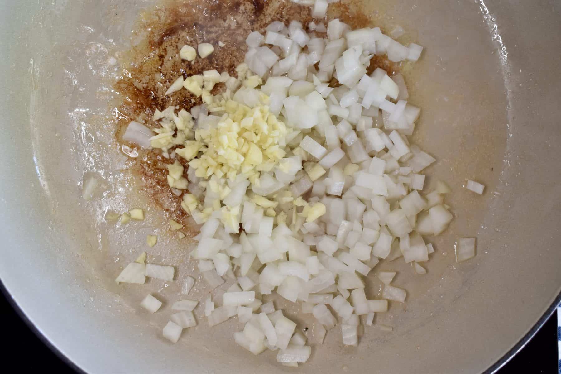 overhead photo of garlic and onion in pan. 
