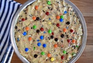 overhead photo of cookie pie in tin with M&M's on top.