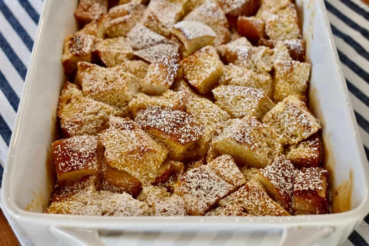 side view of the the casserole with powdered sugar sprinkled overtop. 