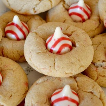 Candy Cane Kiss Cookies piled on a white plate.