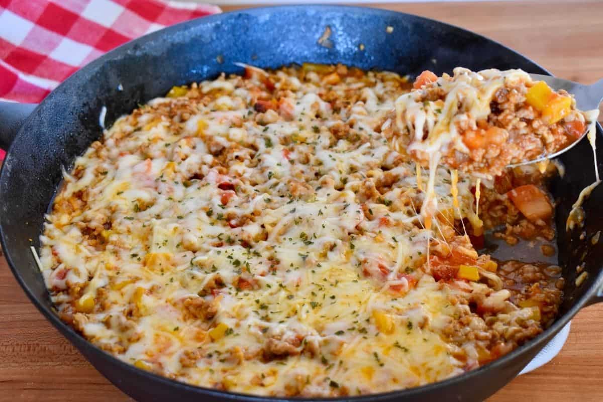 Photo of Stuffed Peppers Skillet with a spoon scooping out some of the recipe. 