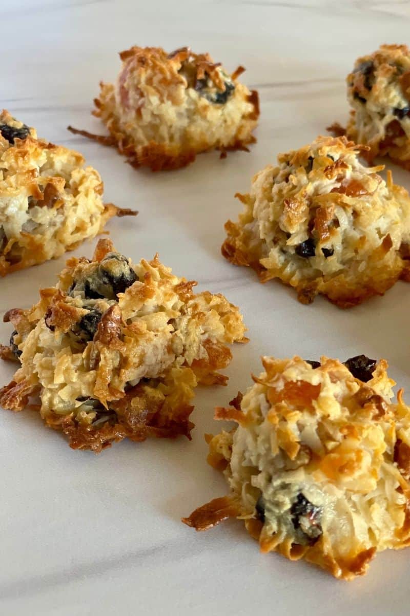 Coconut Macaroons with dried fruit and nuts on a white countertop. 