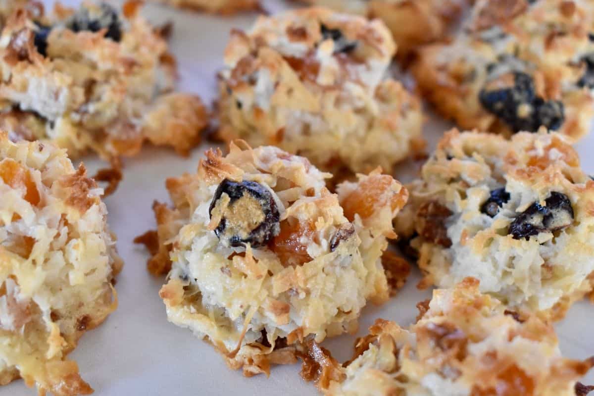 Coconut Macaroons with dried fruit and nuts on a white countertop. 